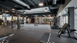 A gym with various exercise equipment, including benches and weight machines. - Nido x Neuchatel Polanco (Mexico City)