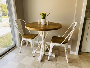 Enjoy meals in this intimate dining area with a round table and two comfortable chairs.