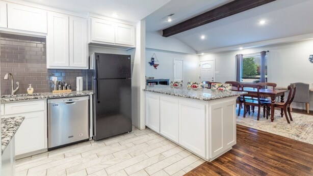 A modern kitchen with white cabinetry, stainless steel appliances, and a granite countertop. - "Stadium Oasis" - A quick walk to the stadiums! (Arlington)