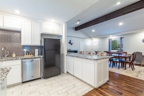 A modern kitchen with white cabinetry, stainless steel appliances, and a granite countertop. - "Stadium Oasis" - A quick walk to the stadiums! (Arlington)