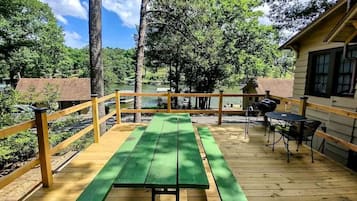 Enjoy a meal on the deck surrounded by nature and a tranquil body of water.