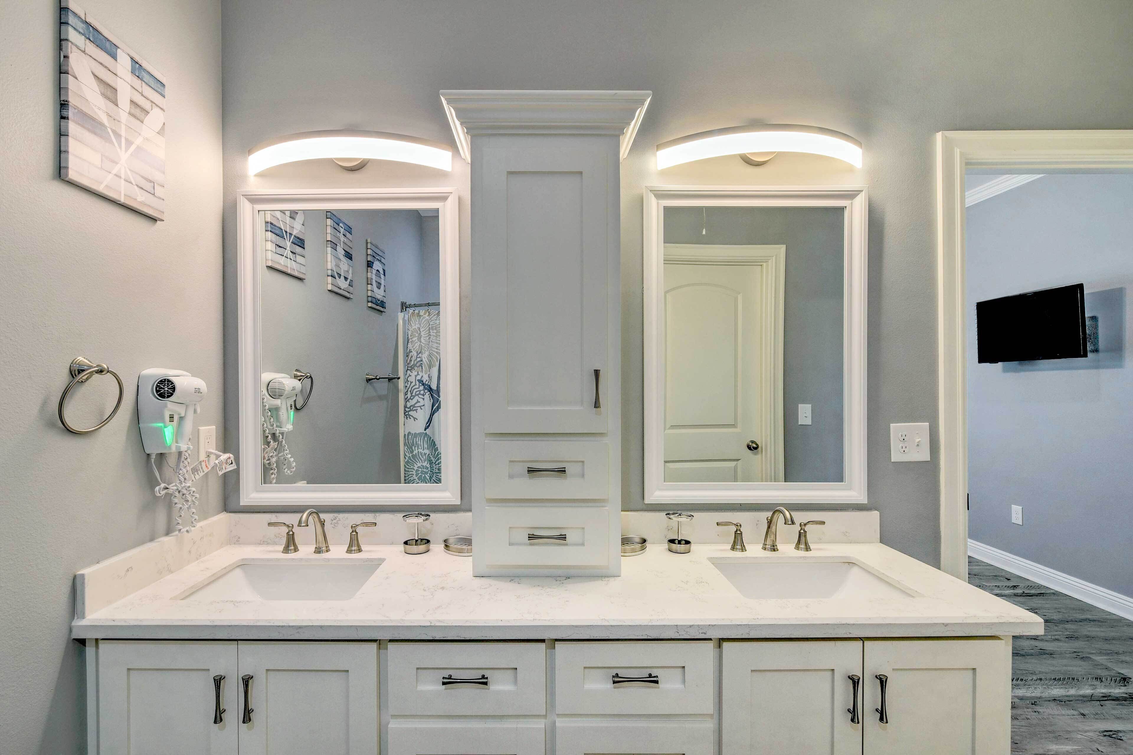 A bathroom with a double vanity, two sinks, and a large mirror.