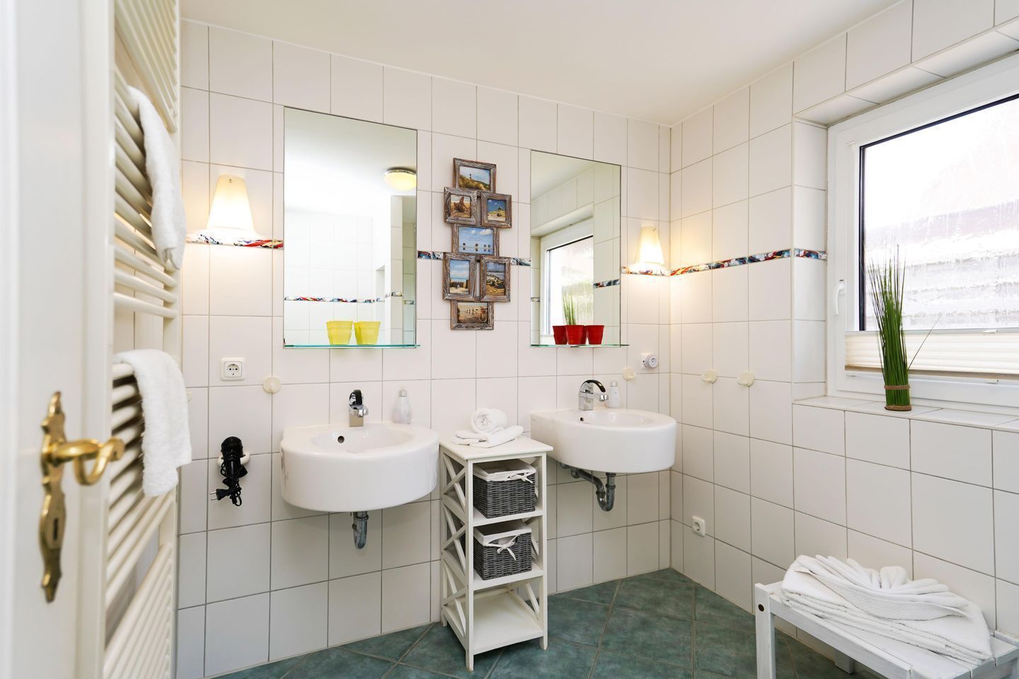 Un baño moderno con dos lavamanos, un espejo y un ventanal con vistas.