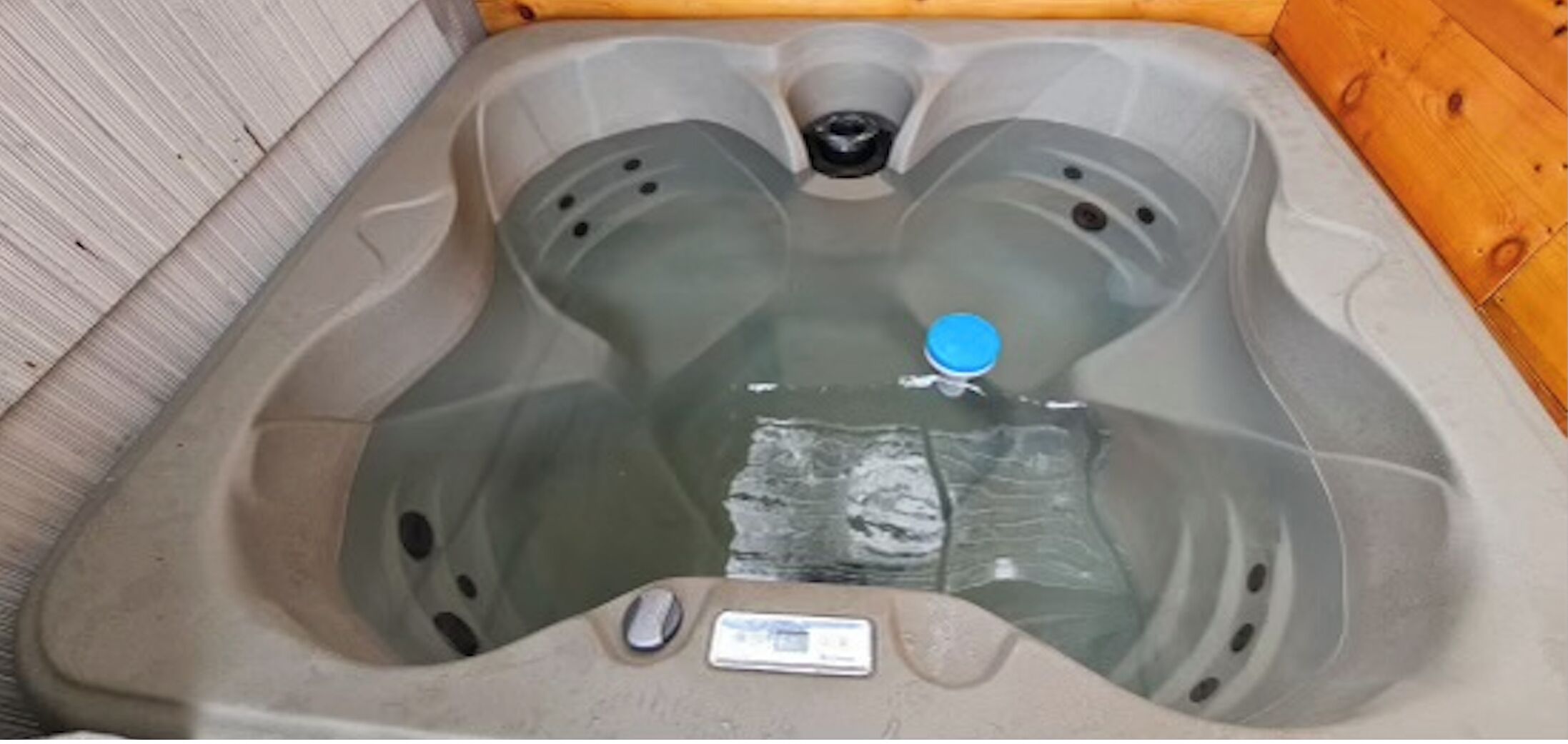 A hot tub with a digital control panel and a blue lid.