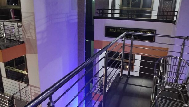 A multi-level interior with metal railings, a staircase, and a sign indicating 'Washington Square'.