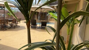 A patio area with outdoor furniture and a pool. - CLOSE TO DISNEYLAND & CONVENTION CENTER  (Anaheim)