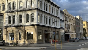 A historic building with arched windows and a fire escape. - Four bedrooms over looking queens gardens (Dunedin)