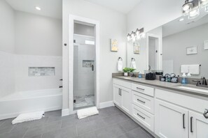 Bathtub, hair dryer, bathrobes, slippers