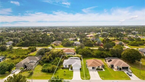 An aerial view of a residential neighborhood with houses, lawns, and trees. - CHARMING FLORIDA GETAWAY 3BDR HOME WITH A POOL (Rotonda West)