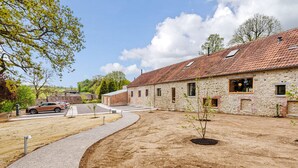 A stone building with a tiled roof, a paved driveway, and a small tree in the foreground. - Lookout -  Lower Wraxall, Cattistock (Dorchester)