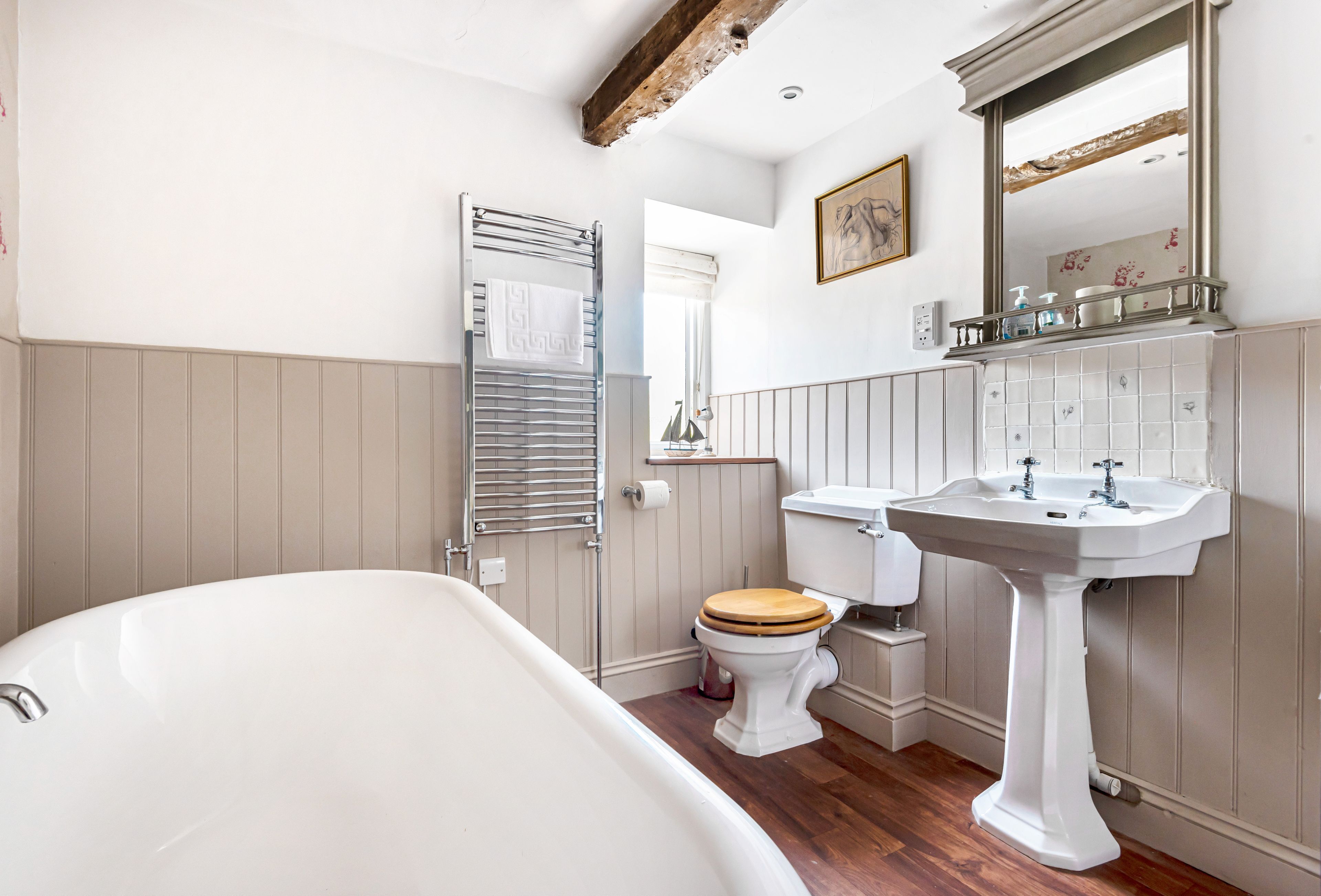 A bathroom with a bathtub, toilet, and sink.