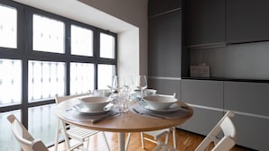 A dining area with a round table set for two, surrounded by white chairs. - Italianway - Frisi 8 (Milan)