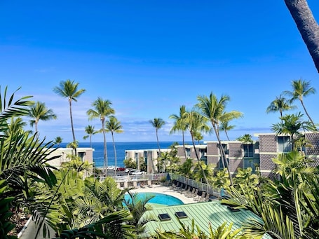 Outdoor pool, a heated pool. Ocean View Condo in the Heart of Kona