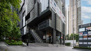 A modern building with a glass facade, a staircase leading to an upper level, and a sign for Staybridge Suites.