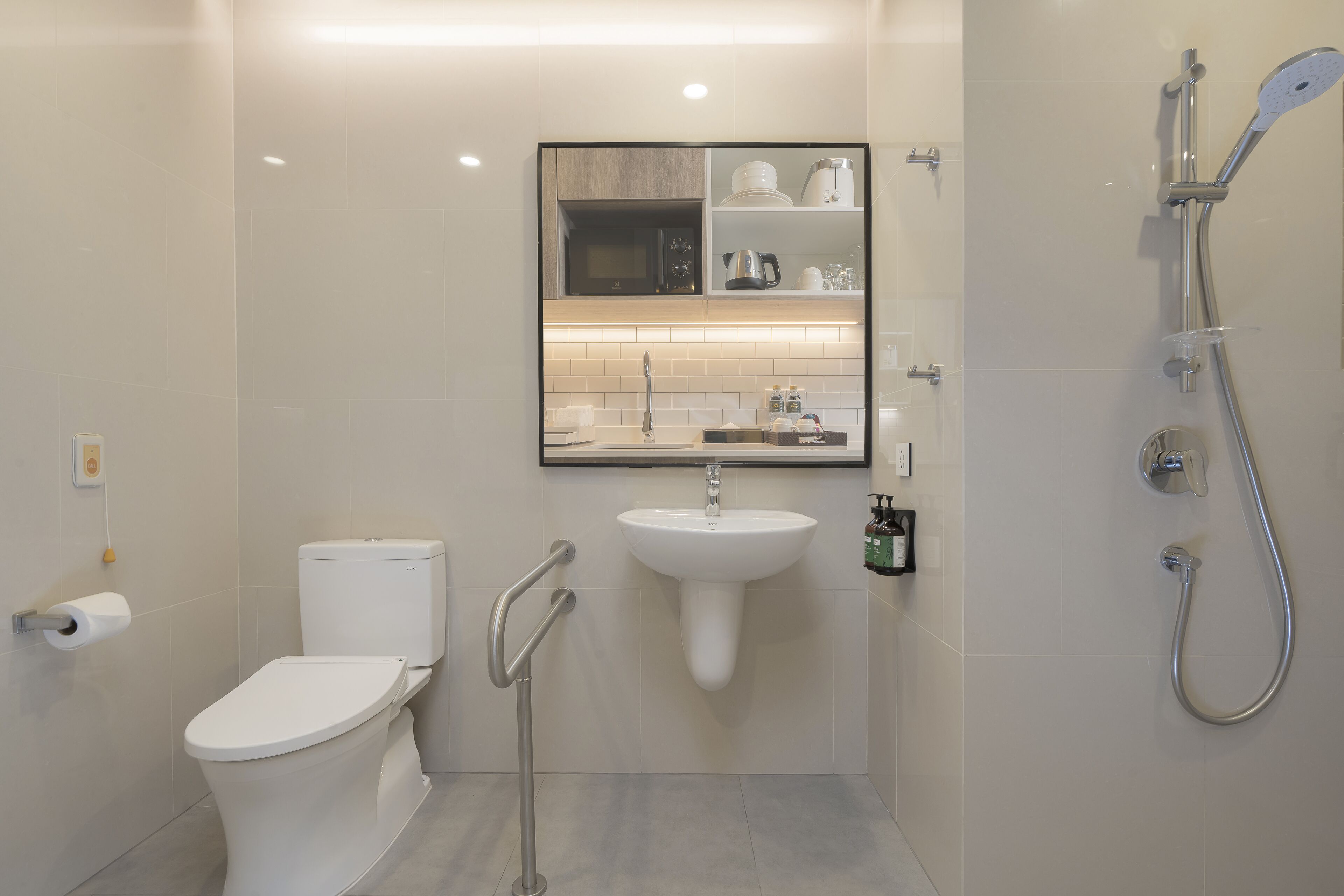 A modern bathroom with a toilet, sink, and shower.