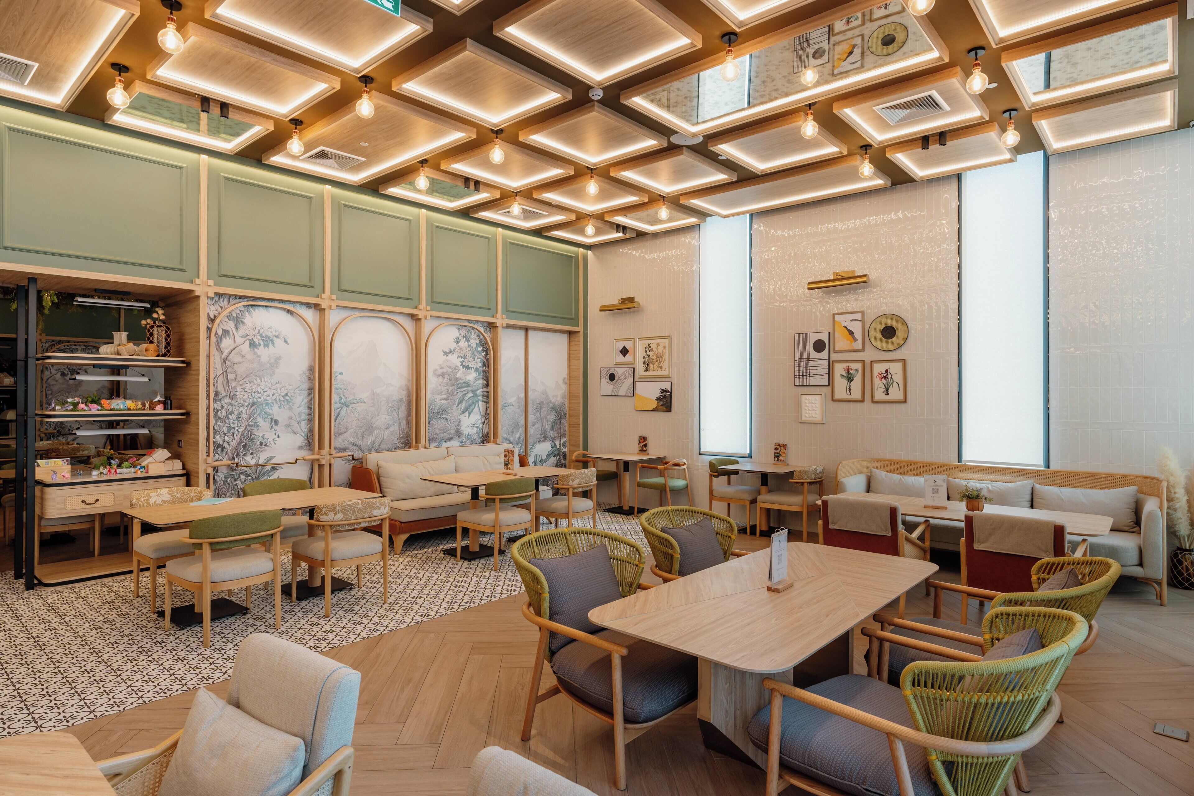 A modern interior with wooden furniture, a patterned floor, and a ceiling with recessed lighting.