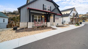 A two-story building with a stone facade and a red roof, labeled "GAME DAY Lodge." - Private Basketball Court/Hot Tub-Community Pools (Branson)