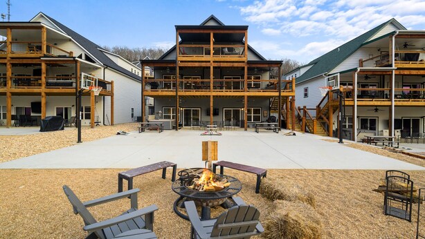 A multi-story building with outdoor seating and a fire pit.