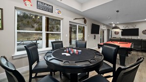A room with a pool table, poker table, and large windows. - Private Basketball Court/Hot Tub-Community Pools (Branson)