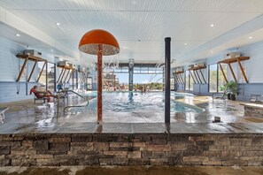 Relax by the pool surrounded by lounge chairs and a sunbed.