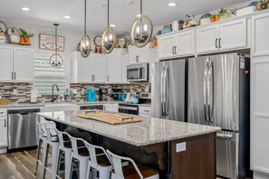 Enjoy cooking in this well-lit kitchen with a central island and stainless steel appliances.