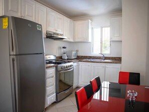 Fridge, cookware/dishes/utensils, dining tables
