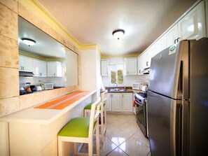 Fridge, cookware/dishes/utensils, dining tables