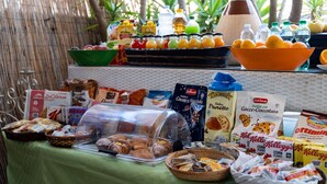 A buffet with various food items and beverages.