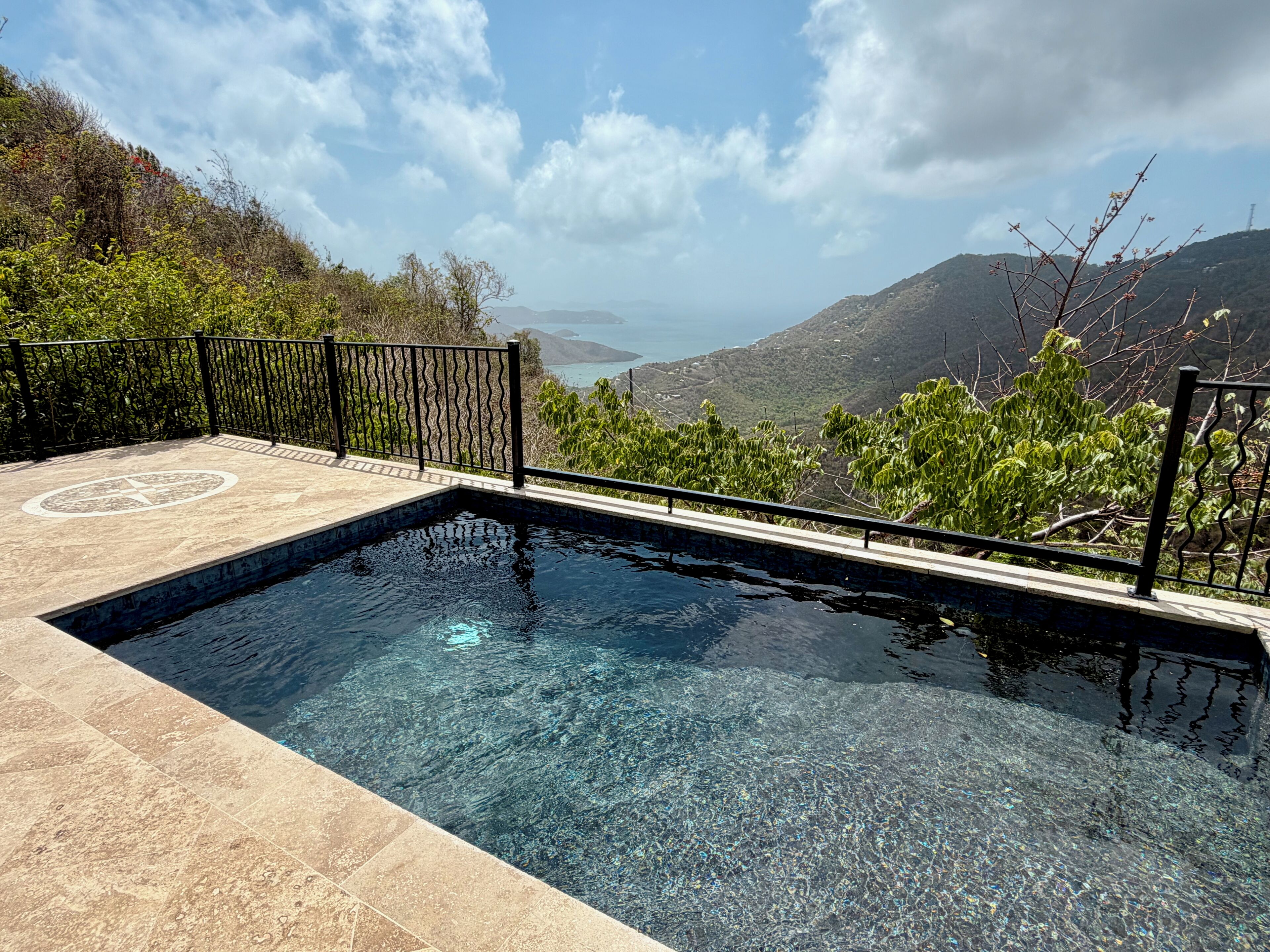 A swimming pool with a clear view of a mountainous landscape.