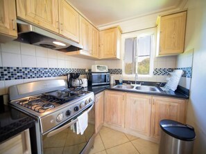Fridge, cookware/dishes/utensils, dining tables