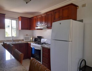 Fridge, cookware/dishes/utensils, dining tables