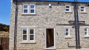 A stone building with multiple windows and a door. - Host & Stay | Foggyshaw Lodge (Middlesmoor)