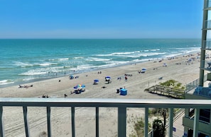 A beach with umbrellas and people. - Spacious, fully renovated corner unit #501. Large balcony, breathtaking views! (Garden City)