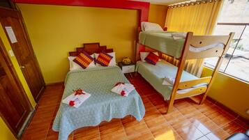 A room with a bunk bed, a wooden wardrobe, and a tiled floor.