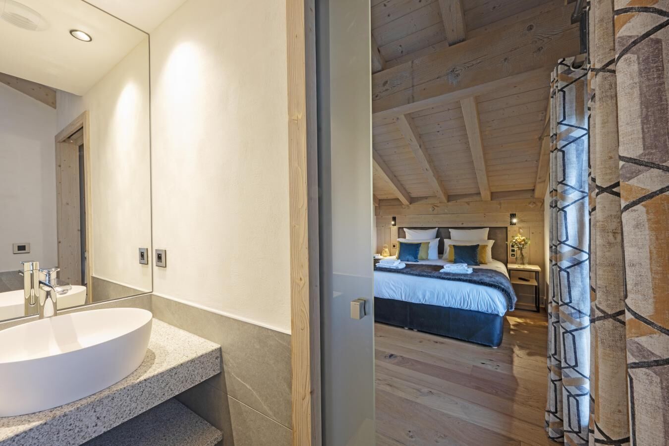 A modern bathroom with a large sink and a separate shower area.