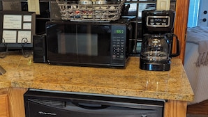 A kitchen with a dishwasher, microwave, toaster, and a coffee maker. - Charming Casita, Old World look with all the modern conveniences. (Rio Rancho)