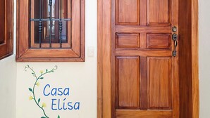 A wooden door with a window and a doorbell. - Huatulco beauty in Chahue Bay. Large family condo with ocean and mountain views (Chahue)