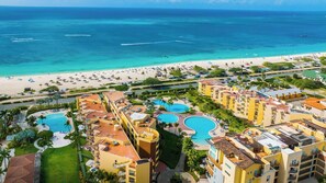 A resort with multiple swimming pools, a beach, and ocean views. - Glamorous 2-BR Beachfront Condo w/Balcony in Aruba (Noord)