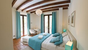 A bedroom with a bed, bedside tables, a desk, and a chair. - Can Marta - Four Bedroom Apartment, Sleeps 8 (Deya)