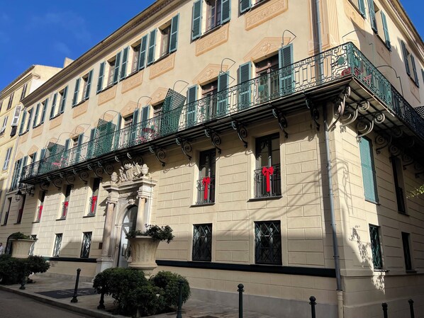 A historic building with ornate balconies, decorative iron railings, and a classical facade.
