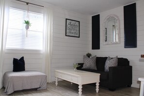 Cozy living room with a comfortable seating area, coffee table, and inspirational quote on the wall.