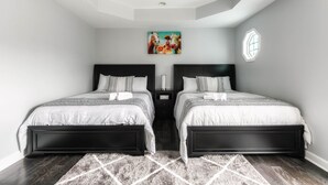 A modern bedroom with two beds, a geometric ceiling design, and a painting on the wall. - Central Charm: 5min to Broadway & DT, Free Coffee! (Nashville)
