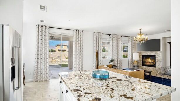 A modern kitchen with a large island, a built-in oven, and a fireplace. - Beautiful 5 BR house with Olympic size Pool and SPA in Indio (Indio)