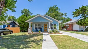 A single-story house with a front porch, a garage, and a well-maintained lawn.