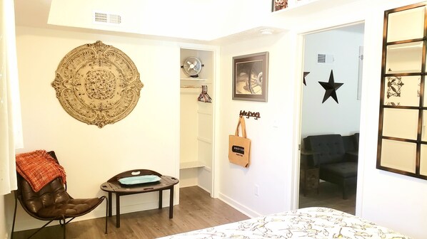 A room with a brown leather chair, a small table with a blue tray, a decorative wall piece, a framed picture, and a star decoration. - Old Farm Land by Willamette River Oak Trees Bike Path Shopping Restaurants (Eugene)