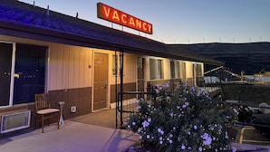 A building with a 'VACANCY' sign, wooden exterior, and a small porch area. - BIGGS NU-VU MOTEL (Biggs Junction)