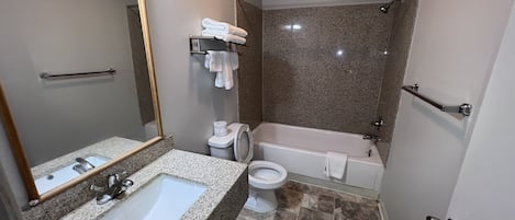 A bathroom with a sink, toilet, and bathtub.