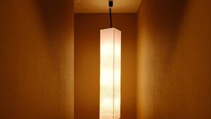 A narrow hallway with a rectangular light fixture hanging from the ceiling. - FOUR SEASONS INN KYOTO (Kyoto)