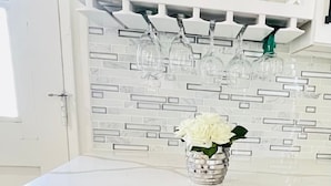 A kitchen with a built-in wine cooler, a white backsplash, and a glass-fronted cabinet above the counter. - 45% OFF 5B/3B 2 Master Bedrooms Close Pasadena, DTLA, Arcadia - Best Locations (Monrovia)