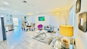 A spacious living area with a dining table, comfortable seating, and a modern lamp. - 45% OFF 5B/3B 2 Master Bedrooms Close Pasadena, DTLA, Arcadia - Best Locations (Monrovia)